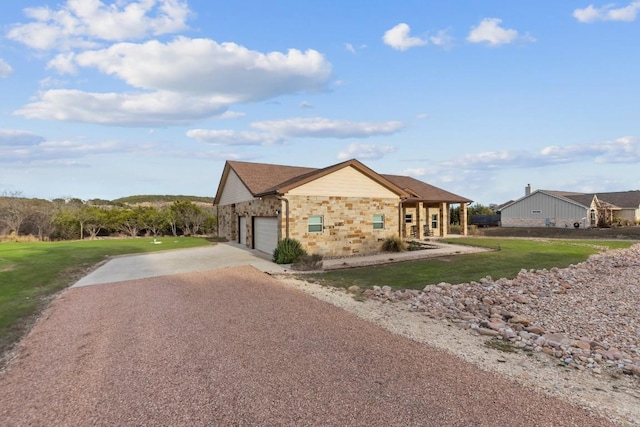 ranch-style house featuring a garage and a front lawn