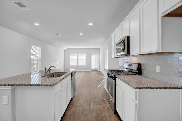 kitchen featuring white cabinets, sink, wood-type flooring, and stainless steel appliances