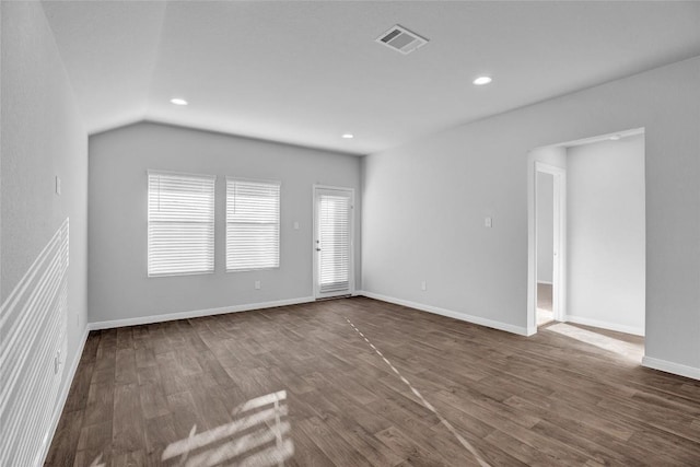 unfurnished room with dark hardwood / wood-style flooring and lofted ceiling