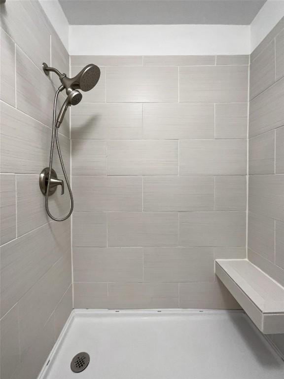 bathroom with tiled shower