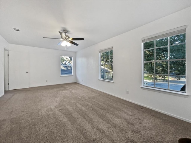 carpeted spare room with ceiling fan