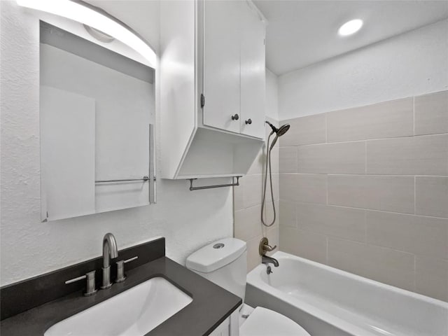 full bathroom featuring vanity, toilet, and tiled shower / bath