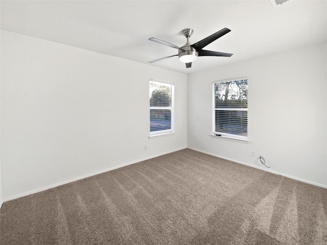 carpeted spare room with ceiling fan