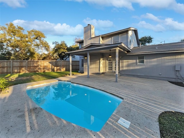 view of swimming pool featuring a deck and ceiling fan