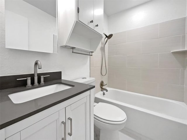 full bathroom with vanity, toilet, and tiled shower / bath