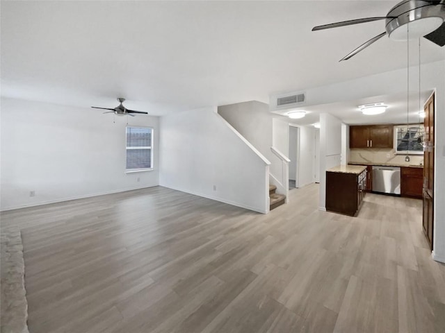 unfurnished living room featuring light wood-type flooring and ceiling fan