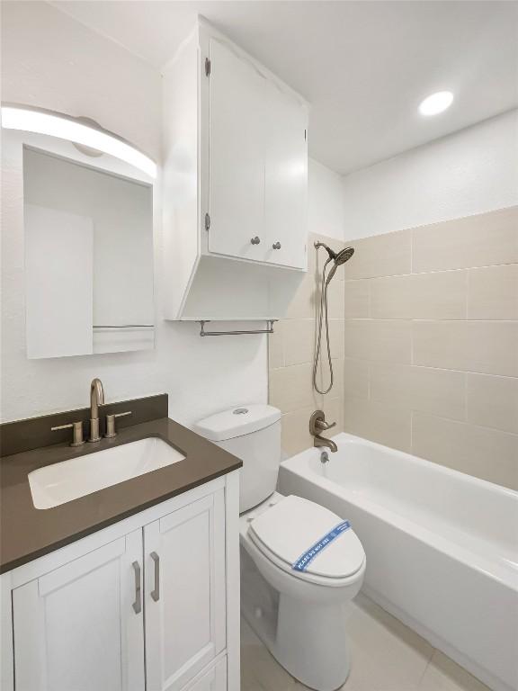 3424 Clarksburg Dr, Austin, TX 78745 - bathroom featuring toilet, vanity,  shower combination, and tile patterned floors