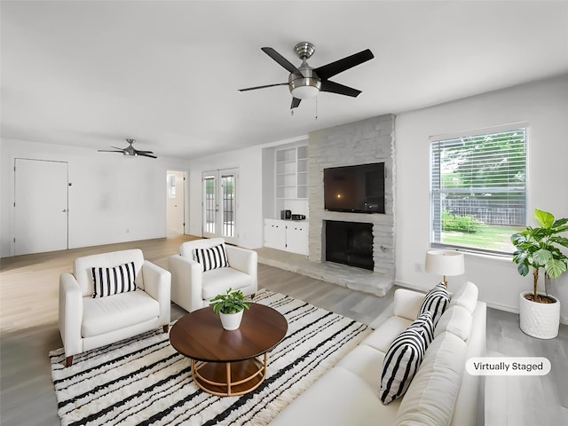 3424 Clarksburg Dr, Austin, TX 78745 - living area featuring a ceiling fan, wood finished floors, built in shelves, and plenty of natural light