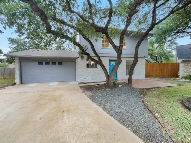 3424 Clarksburg Dr, Austin, TX 78745 - view of front of home featuring driveway, a garage, and stucco siding