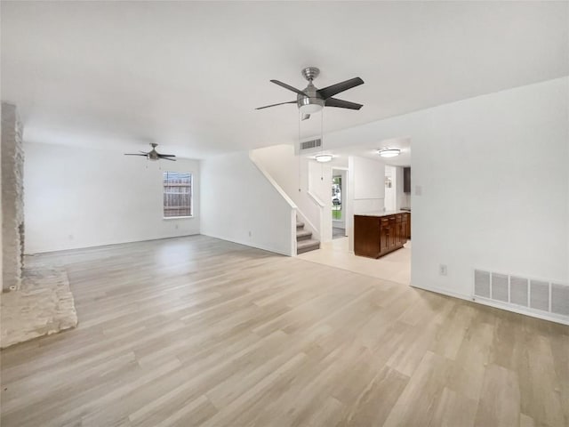 3424 Clarksburg Dr, Austin, TX 78745 - unfurnished living room with ceiling fan, stairway, light wood finished floors, and baseboards