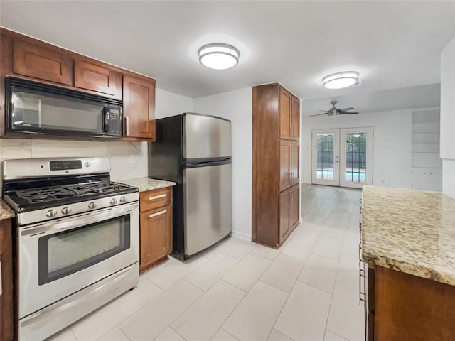 3424 Clarksburg Dr, Austin, TX 78745 - kitchen with stainless steel appliances, french doors, ceiling fan, and brown cabinetry