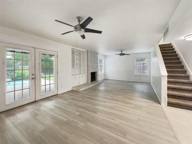 3424 Clarksburg Dr, Austin, TX 78745 - unfurnished living room featuring a ceiling fan, stairway, light wood-style flooring, french doors, and baseboards