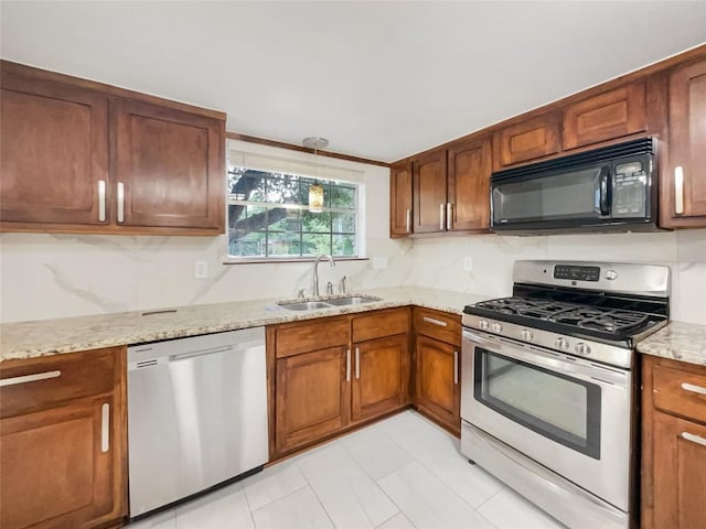 3424 Clarksburg Dr, Austin, TX 78745 - kitchen with appliances with stainless steel finishes, a sink, decorative backsplash, and light stone countertops