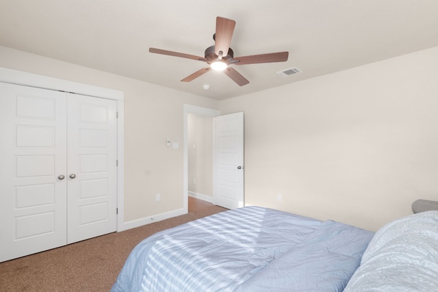 carpeted bedroom featuring ceiling fan and a closet