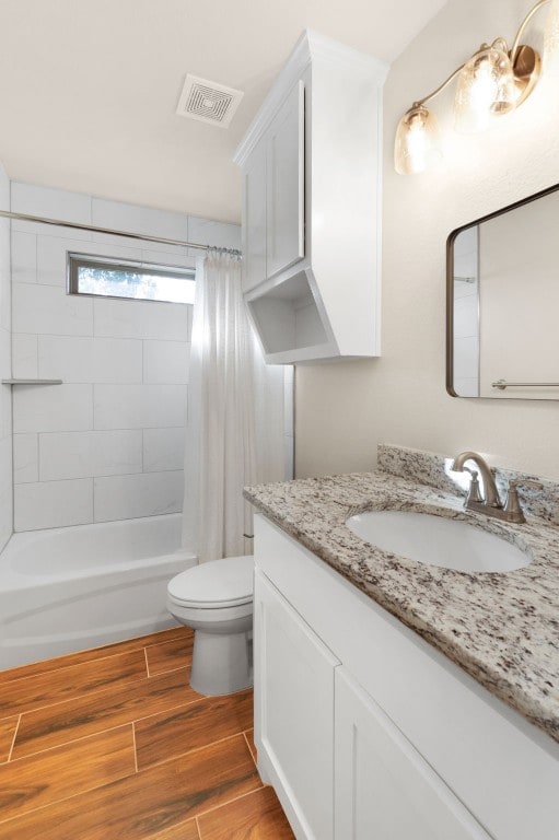 full bathroom featuring vanity, shower / bath combo, and toilet