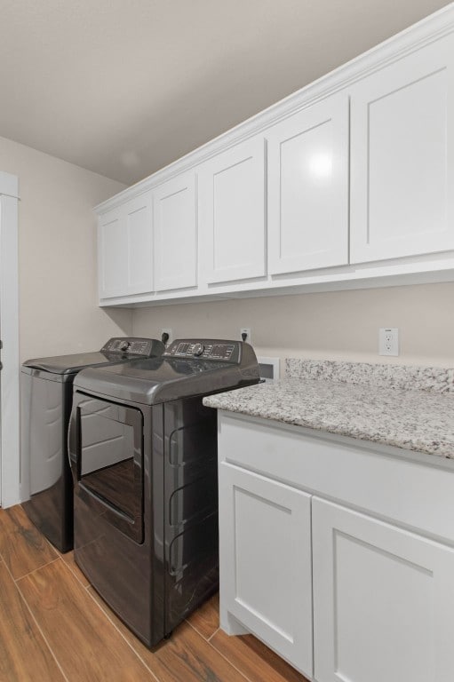 laundry area featuring cabinets and separate washer and dryer