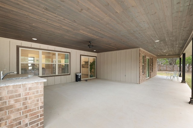 view of patio featuring ceiling fan and sink