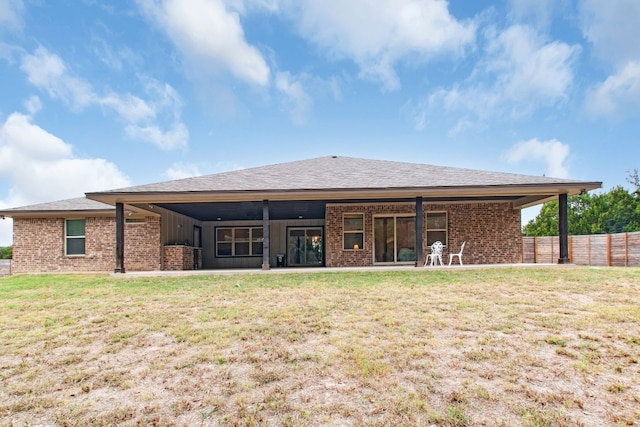 rear view of house with a yard