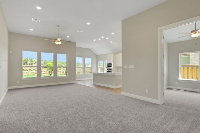 unfurnished living room featuring light carpet, baseboards, a ceiling fan, and visible vents