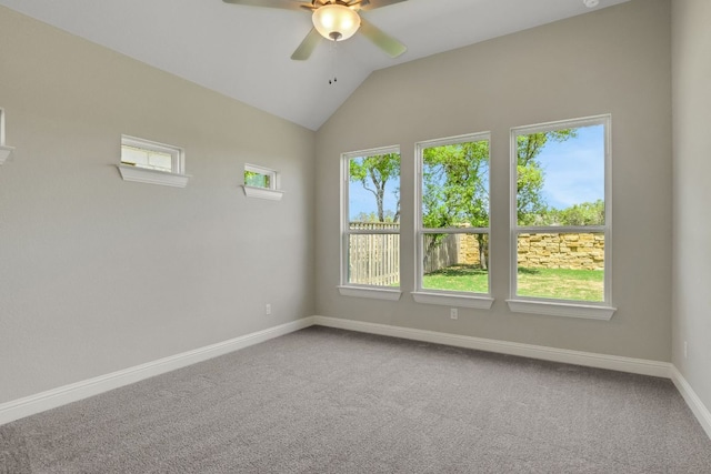 carpeted spare room featuring baseboards, a ceiling fan, and lofted ceiling