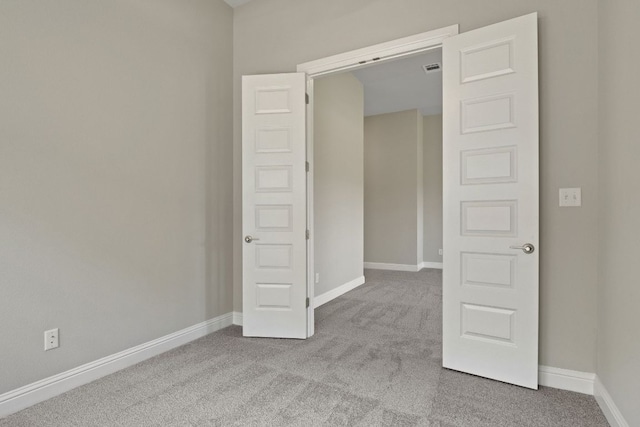 unfurnished bedroom with baseboards and carpet