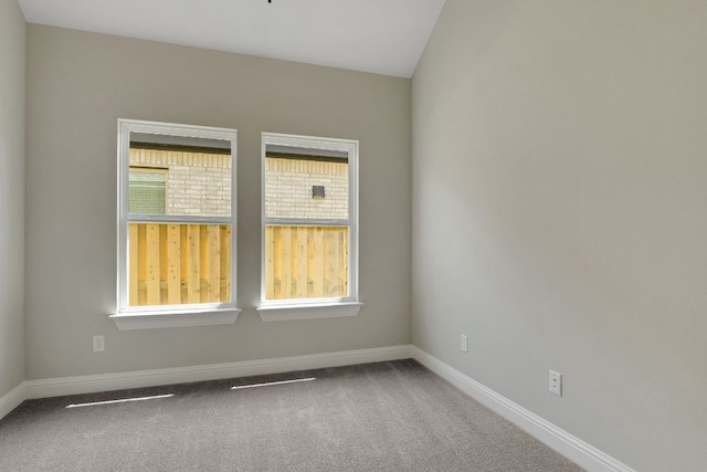 carpeted empty room with baseboards
