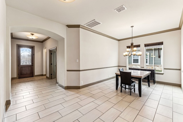 dining area featuring a wealth of natural light, crown molding, and a chandelier