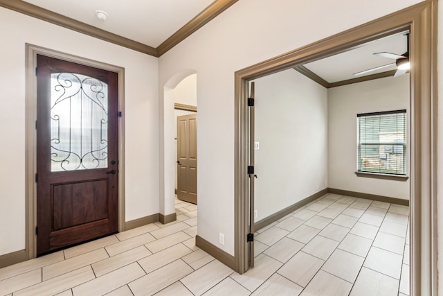 entryway featuring ceiling fan and ornamental molding