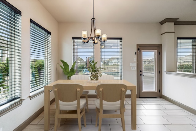 dining room with light tile patterned flooring and a notable chandelier