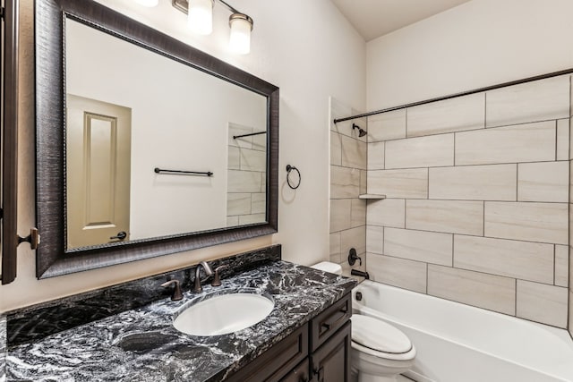 full bathroom featuring vanity, toilet, and tiled shower / bath