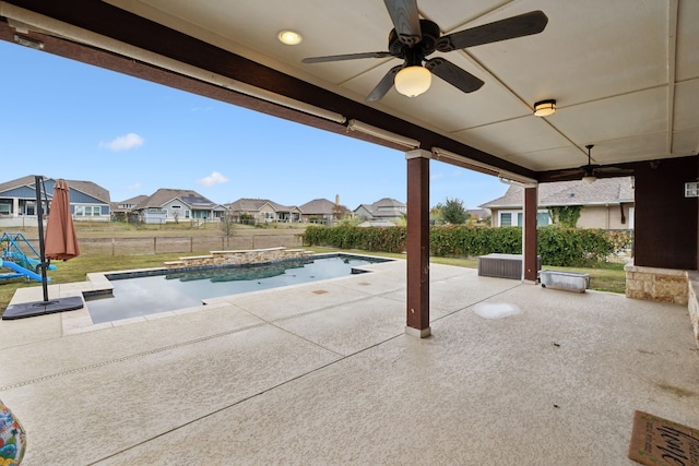 view of patio with ceiling fan and a fenced in pool