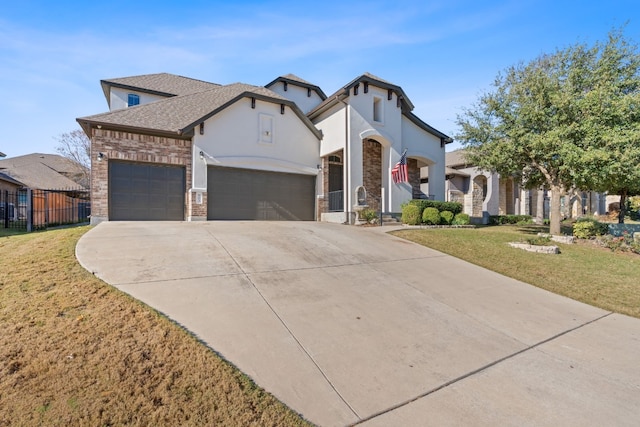 view of front of property featuring a garage and a front lawn