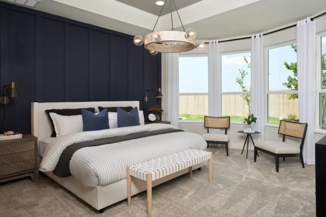 carpeted bedroom featuring a raised ceiling