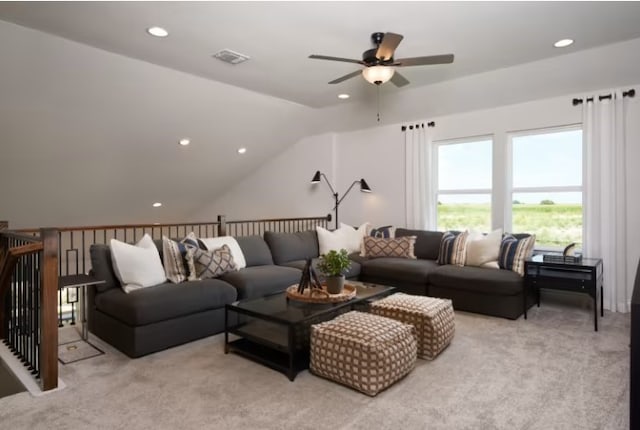 carpeted living room with ceiling fan and lofted ceiling