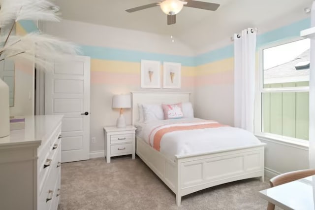 bedroom with multiple windows, light carpet, ceiling fan, and lofted ceiling