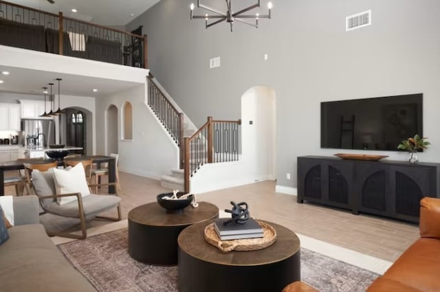 living room featuring a high ceiling and an inviting chandelier