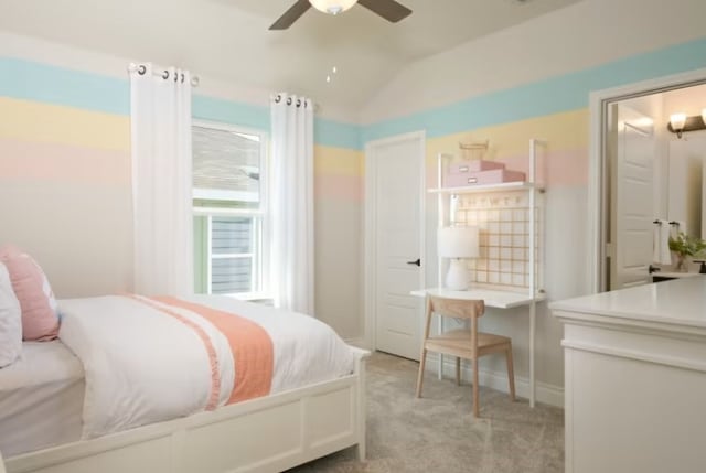 carpeted bedroom with ceiling fan and vaulted ceiling