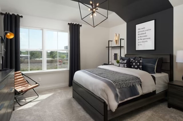 carpeted bedroom featuring an inviting chandelier