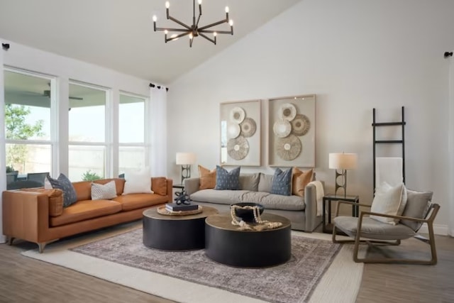 living room featuring wood-type flooring, high vaulted ceiling, and a chandelier