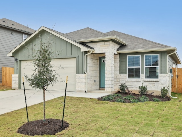 view of front of home featuring a garage and a front lawn