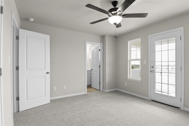 unfurnished bedroom featuring ensuite bath, light colored carpet, ceiling fan, and access to outside