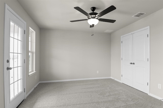 spare room with ceiling fan and carpet