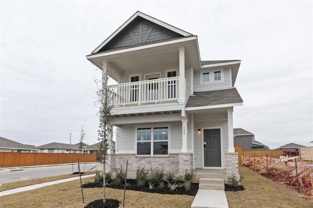 view of front of home with a front lawn and a balcony