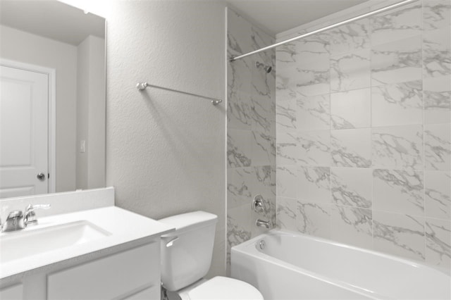 full bathroom featuring toilet, tiled shower / bath, and vanity