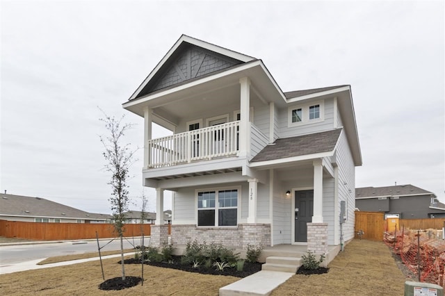 view of front of home featuring a front lawn and a balcony