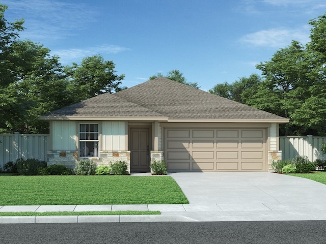 view of front of house with a front yard and a garage