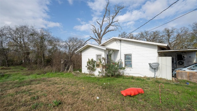 view of side of property with a lawn