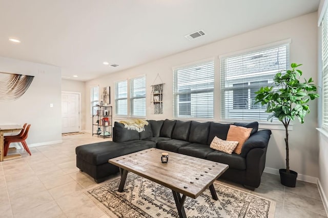 tiled living room featuring a wealth of natural light