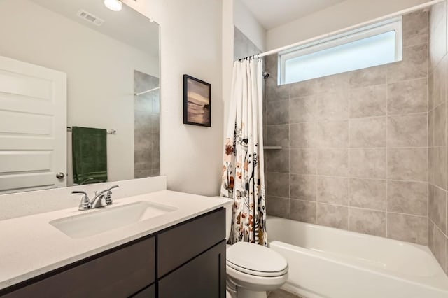 full bathroom featuring shower / tub combo with curtain, vanity, and toilet