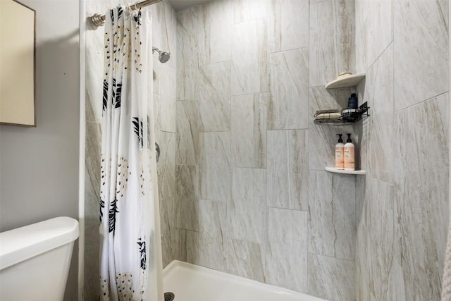 bathroom with a shower with curtain and toilet